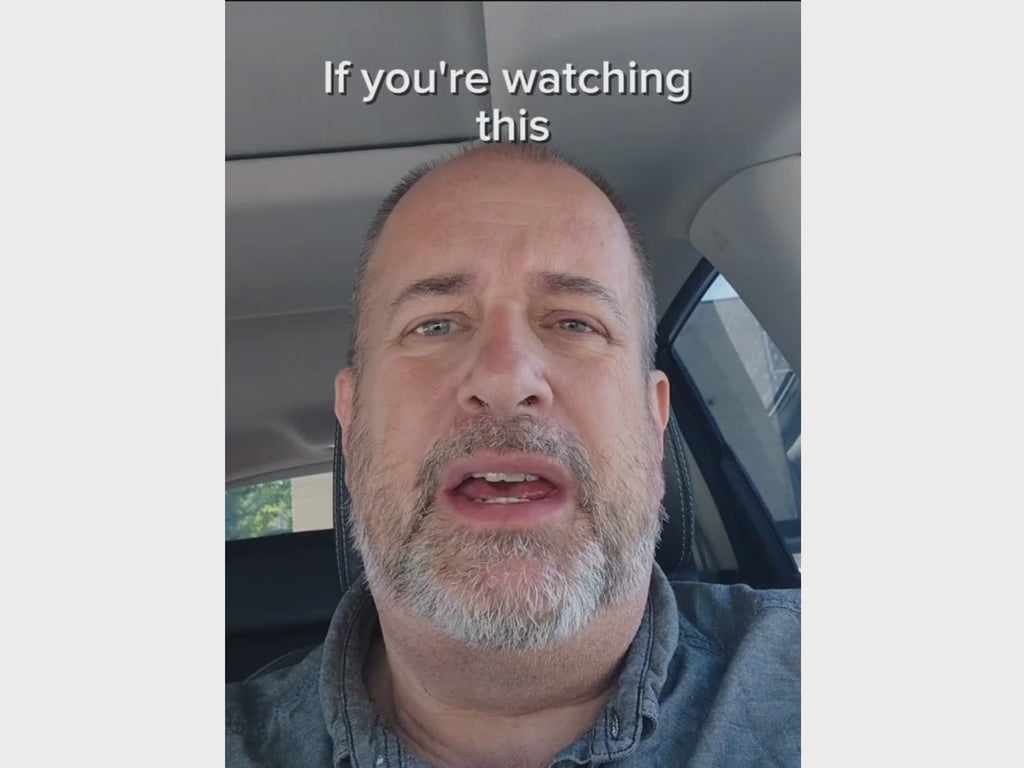 Man in blue shirt talking to camera about Nurses Escape Kit